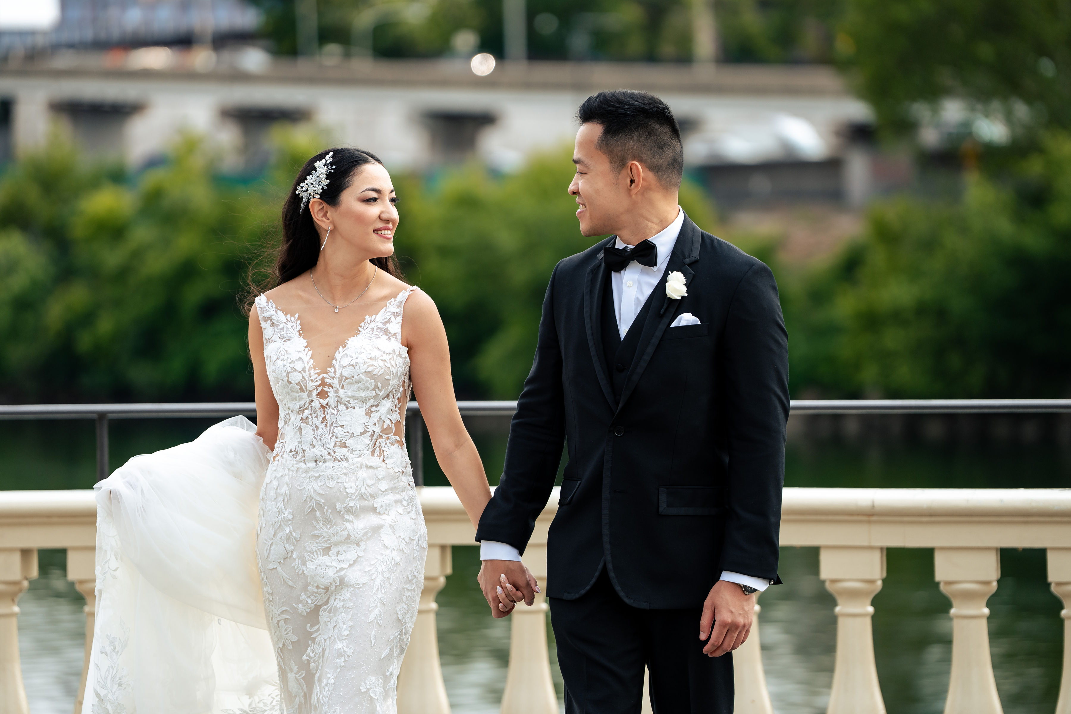 bride-and-groom-walking-together-by-waterfront-venue